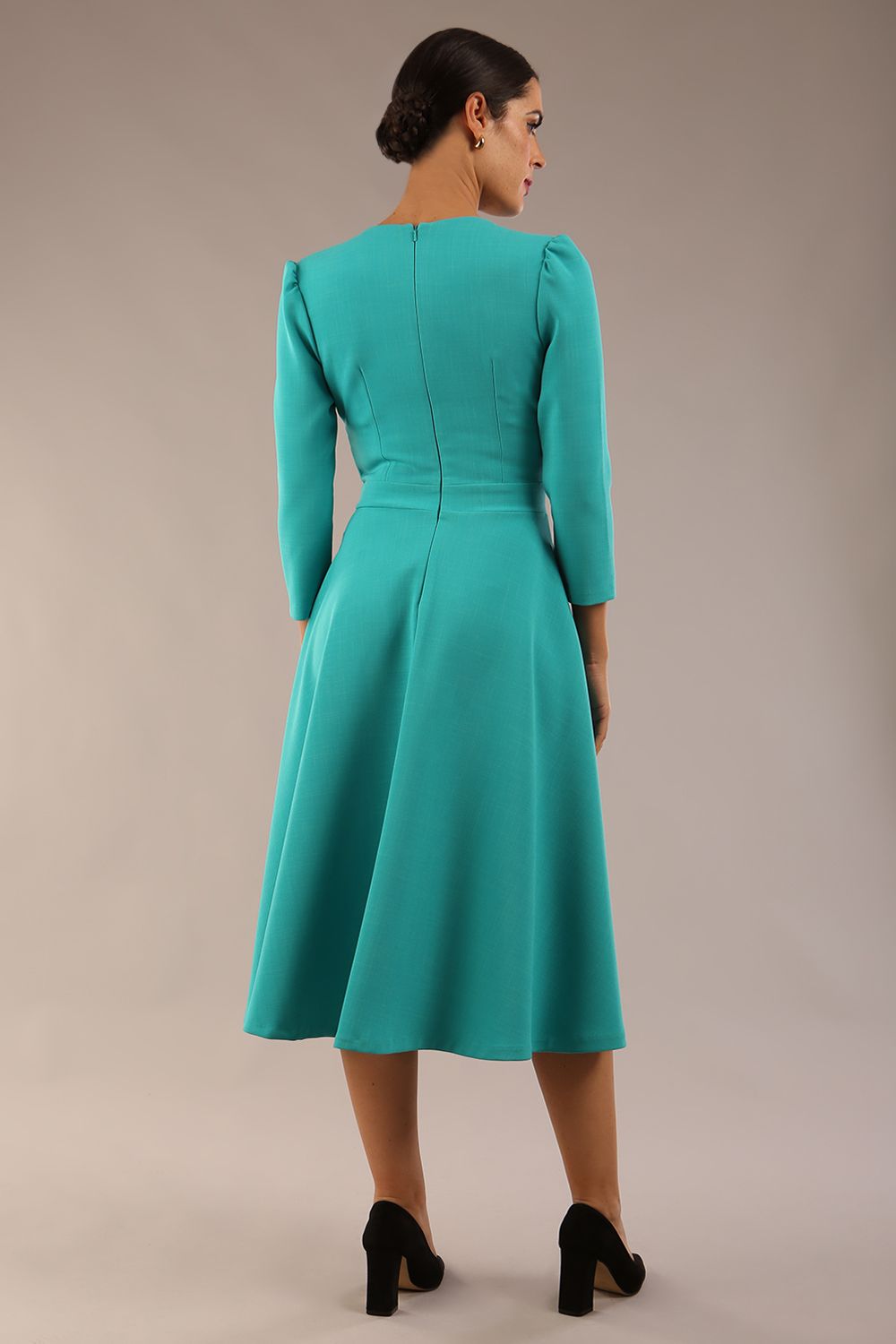 Model wearing diva catwalk Kate 3/4 Length Sleeve A-Line Swing Dress with side pockets in Aqua Green colour back