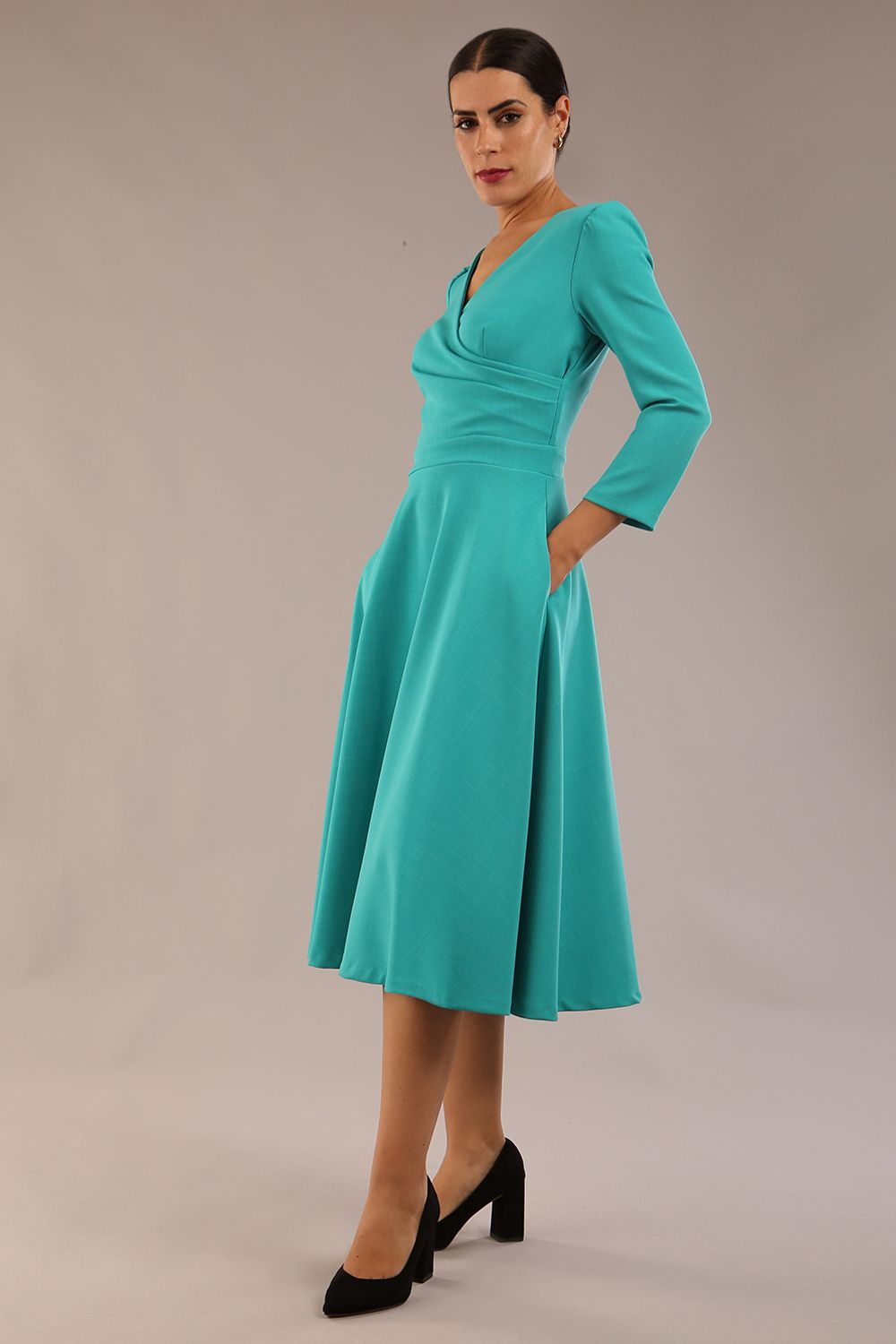 Model wearing diva catwalk Kate 3/4 Length Sleeve A-Line Swing Dress with side pockets in Aqua Green colour