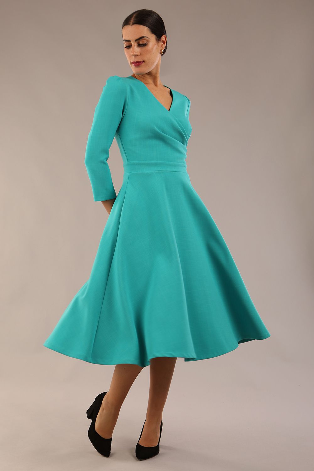 Model wearing diva catwalk Kate 3/4 Length Sleeve A-Line Swing Dress with side pockets in Aqua Green colour