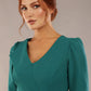 Close-up of the architectural asymmetric folded lapel on the SEED Cyrus dress in pacific green (Pacific Green)