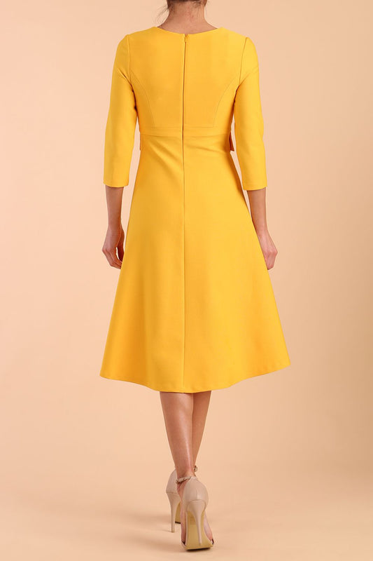 Model wearing diva catwalk Gresham 3/4 Sleeve Knee Length A-Line Dress in Daffodil Yellow back