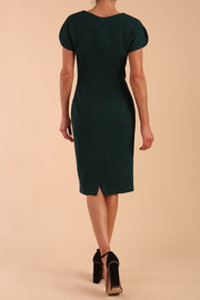 Model wearing a diva catwalk Sheena Short Sleeve with an open split Knee Length Pencil Dress with Diamond Neckline in Forest Green colour back