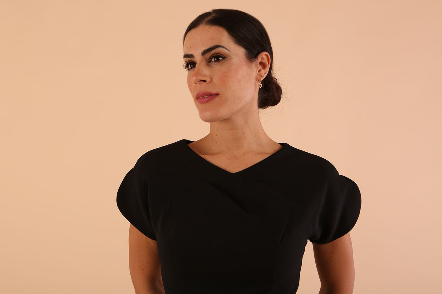 Model wearing a diva catwalk Sheena Short Sleeve with an open split Knee Length Pencil Dress with Diamond Neckline in Black colour