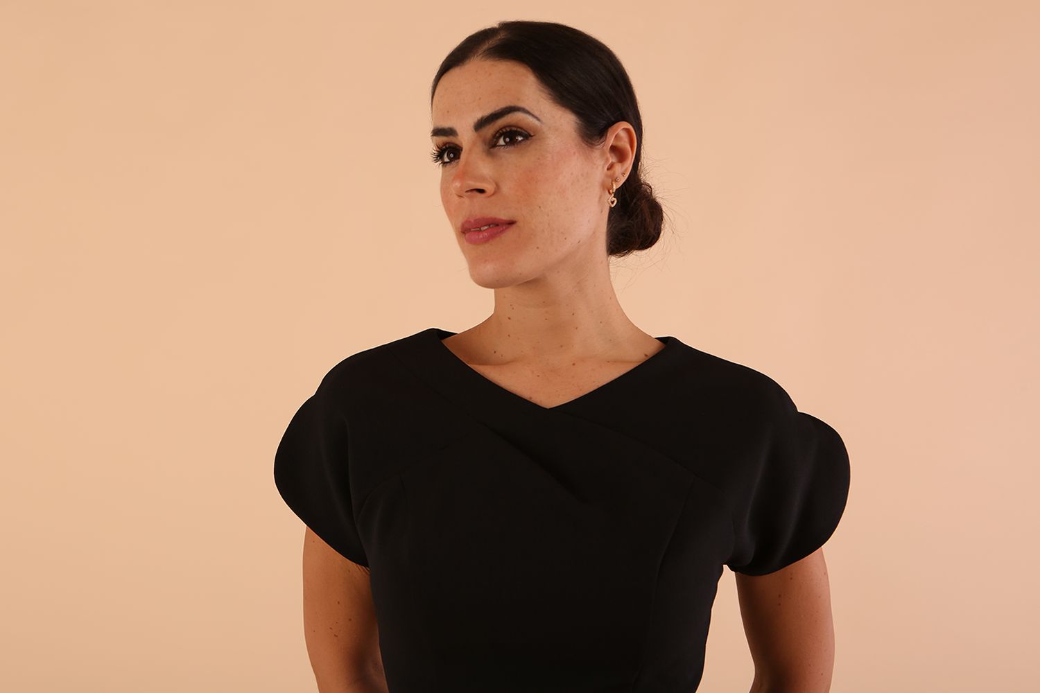 Model wearing a diva catwalk Sheena Short Sleeve with an open split Knee Length Pencil Dress with Diamond Neckline in Black colour