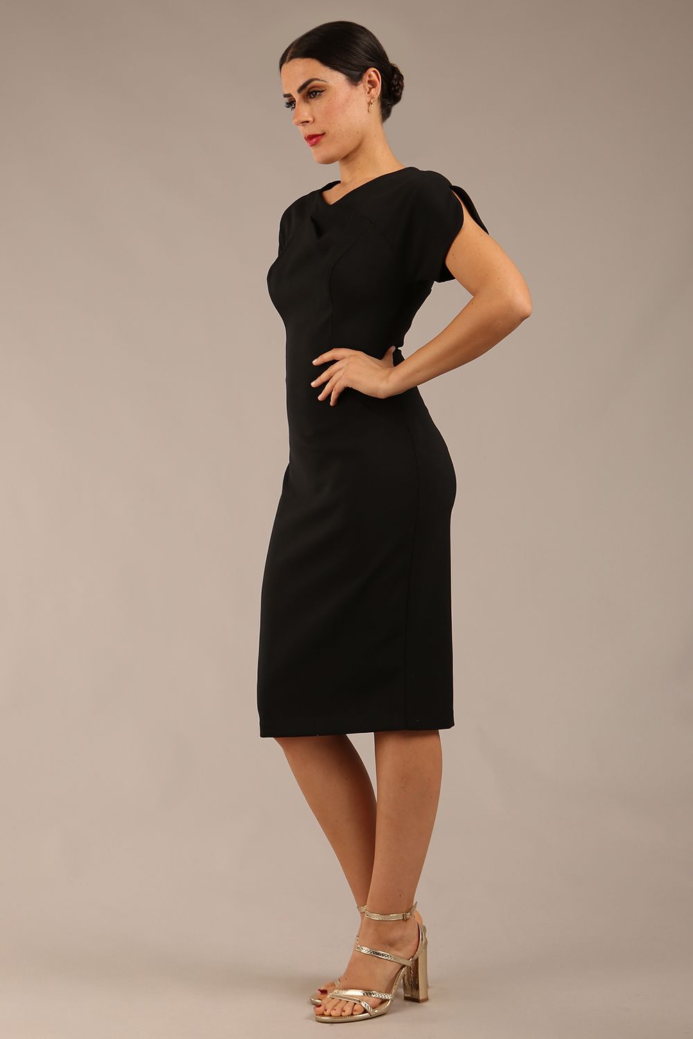 brunette Model wearing a diva catwalk Sheena Short Sleeve with an open split Knee Length Pencil Dress with Diamond Neckline in Black colour front