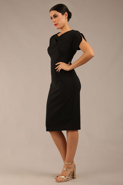 brunette Model wearing a diva catwalk Sheena Short Sleeve with an open split Knee Length Pencil Dress with Diamond Neckline in Black colour front