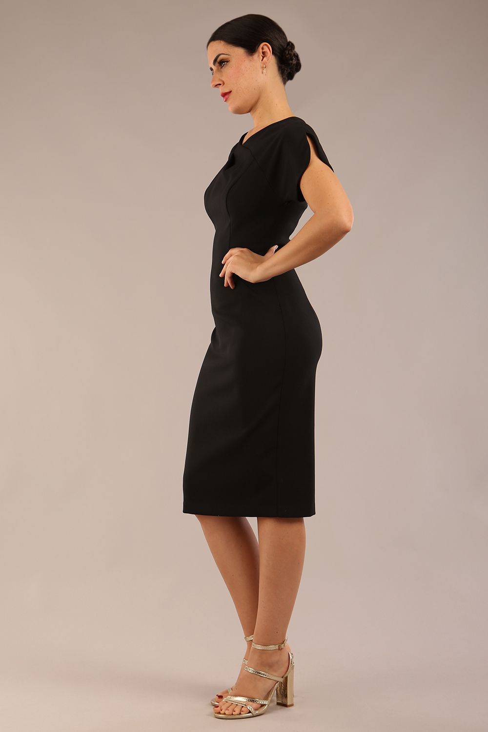 brunette Model wearing a diva catwalk Sheena Short Sleeve with an open split Knee Length Pencil Dress with Diamond Neckline in Black colour front