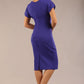 brunette Model wearing a diva catwalk Sheena Short Sleeve with an open split Knee Length Pencil Dress with Diamond Neckline in Indigo Blue colour back