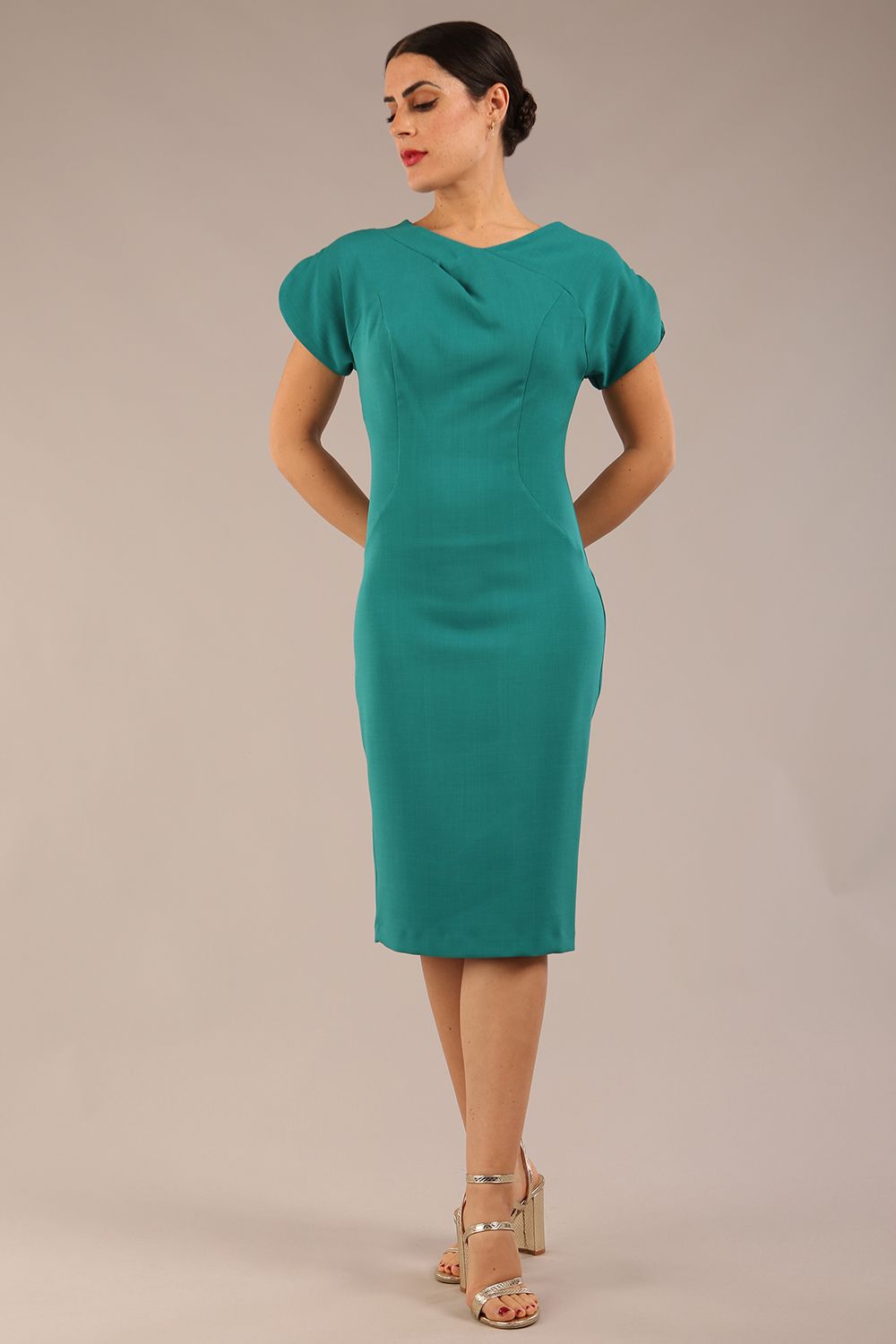 brunette Model wearing a diva catwalk Sheena Short Sleeve with an open split Knee Length Pencil Dress with Diamond Neckline in Parasailing Green colour front