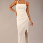 Model wearing Sabrina Maxi Dress with square neckline, sleeveless style, pleating details and side open split, open back in Ivory Cream