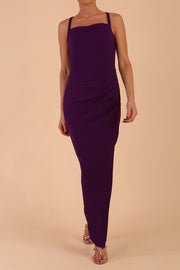 Model wearing Sabrina Maxi Dress with square neckline, sleeveless style, pleating details and side open split, open back in Passion Purple front