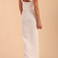 Model wearing Sabrina Maxi Dress with square neckline, sleeveless style, pleating details and side open split, open back in Ivory Cream back