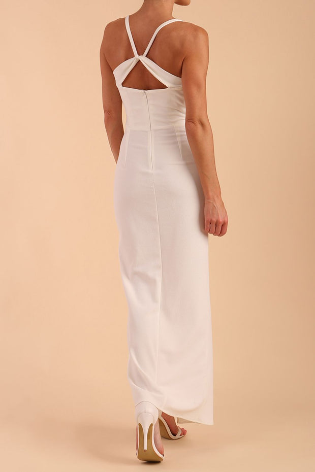 Model wearing Sabrina Maxi Dress with square neckline, sleeveless style, pleating details and side open split, open back in Ivory Cream back