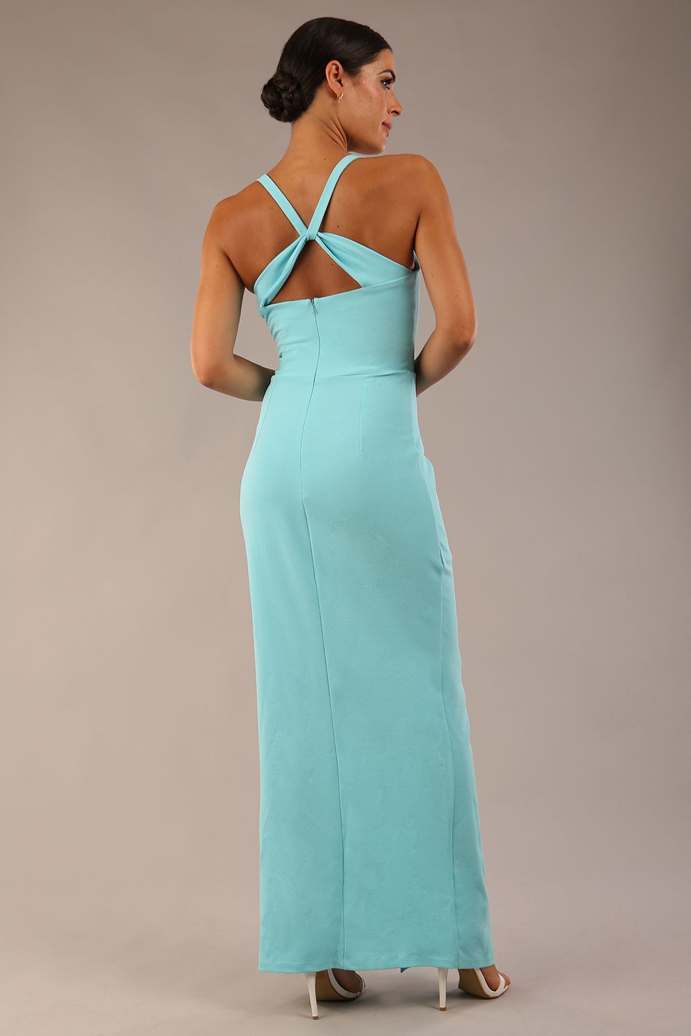 Model wearing Sabrina Maxi Dress with square neckline, sleeveless style, pleating details and side open split, open back in Turquoise