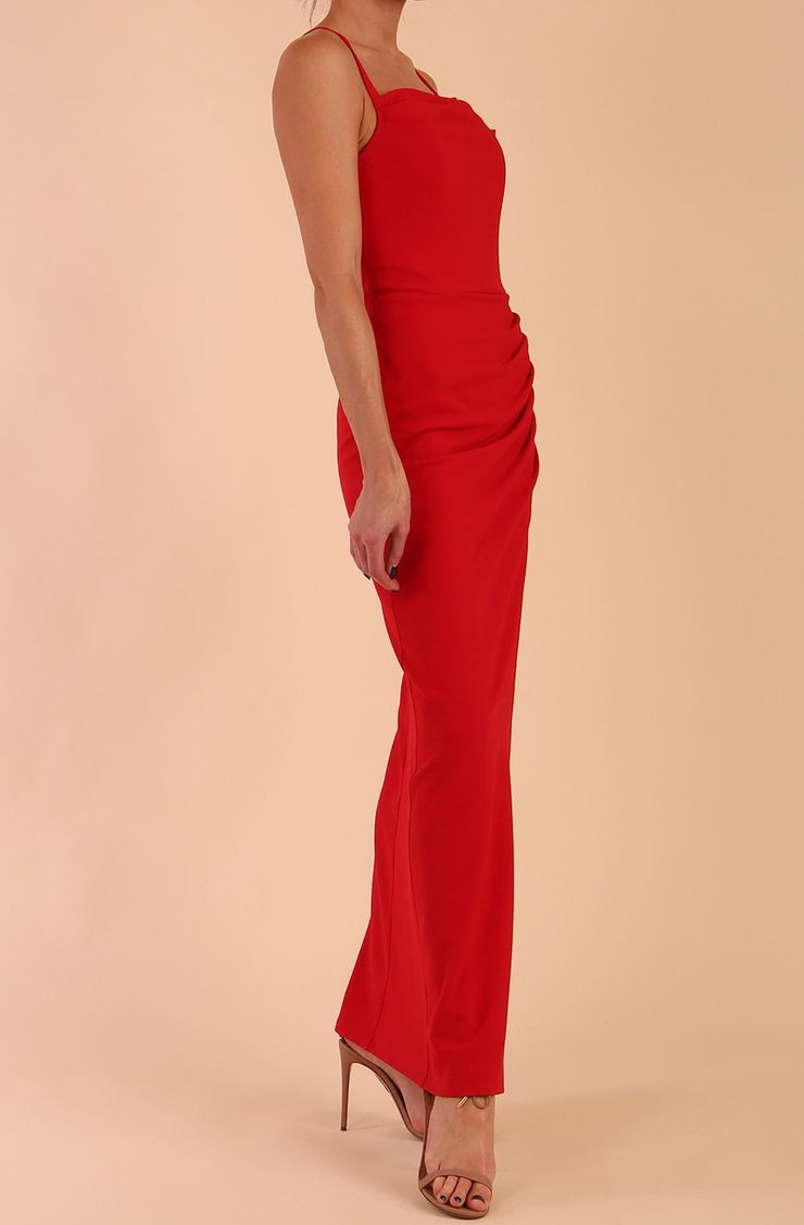 Model wearing Sabrina Maxi Dress with square neckline, sleeveless style, pleating details and side open split, open back in Scarlet Red front side