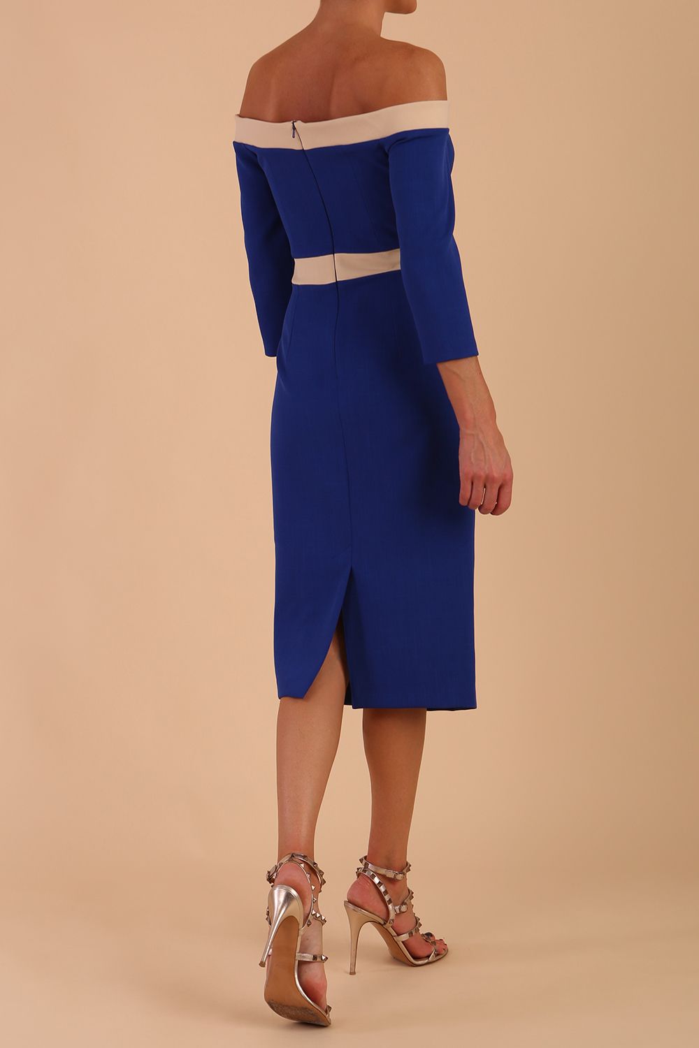 Model wearing a diva catwalk Brittany Off Shoulder Bow detail Pencil Dress with 3/4 sleeves and knee length in Cobalt Blue and Sandshell Beige colour back