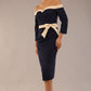 Model wearing a diva catwalk Brittany Off Shoulder Bow detail Pencil Dress with 3/4 sleeves and knee length in Navy Blue and Sandshell Beige colour front side