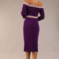 Model wearing a diva catwalk Brittany Off Shoulder Bow detail Pencil Dress with 3/4 sleeves and knee length in Deep Purple and Thunder Bird colour