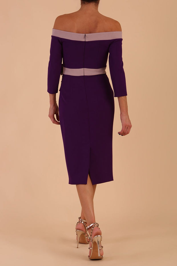 Model wearing a diva catwalk Brittany Off Shoulder Bow detail Pencil Dress with 3/4 sleeves and knee length in Deep Purple and Thunder Bird colour back