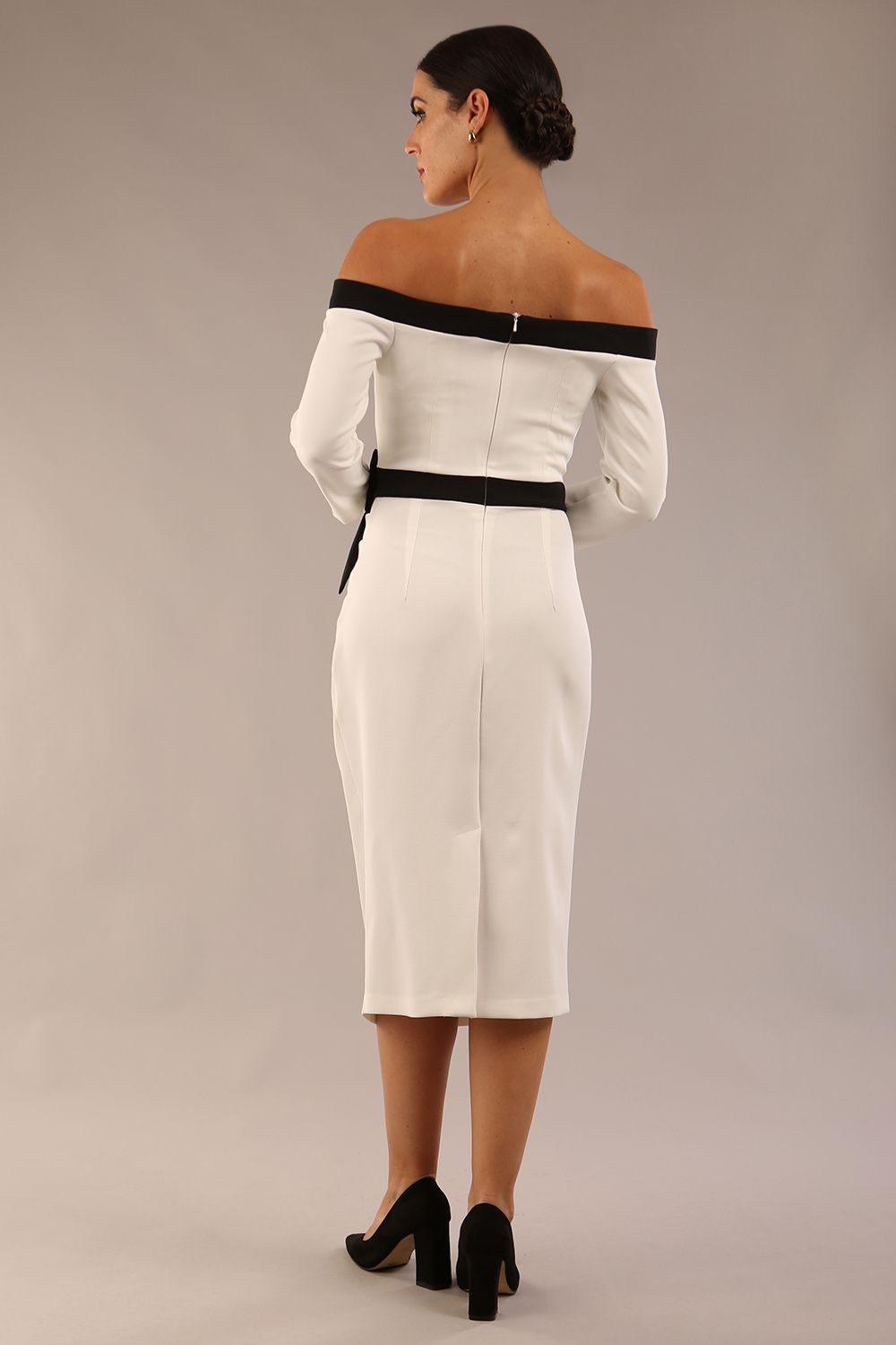 Model wearing a diva catwalk Brittany Off Shoulder Bow detail Pencil Dress with 3/4 sleeves and knee length in Ivory and Black colour