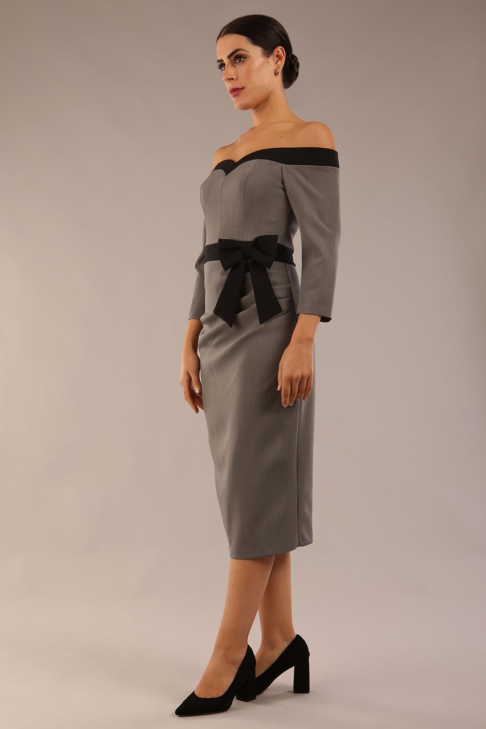 Model wearing a diva catwalk Brittany Off Shoulder Bow detail Pencil Dress with 3/4 sleeves and knee length in Castlerock Grey and Black colour