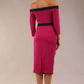 Model wearing a diva catwalk Brittany Off Shoulder Bow detail Pencil Dress with 3/4 sleeves and knee length in Magenta Haze and Navy Blue colour