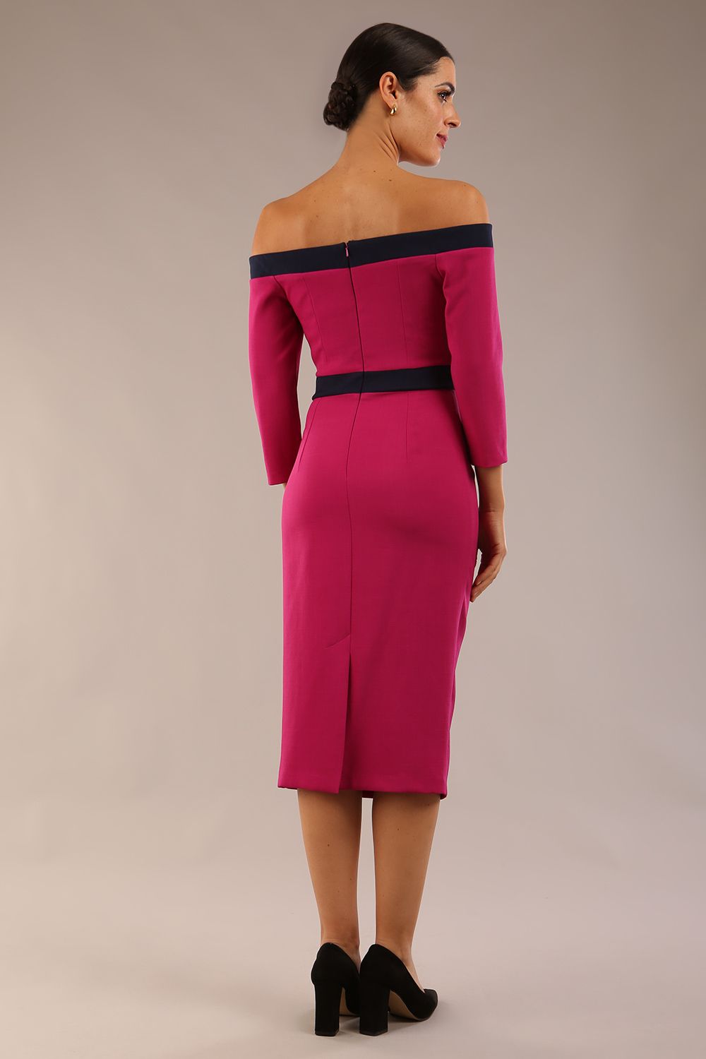 Model wearing a diva catwalk Brittany Off Shoulder Bow detail Pencil Dress with 3/4 sleeves and knee length in Magenta Haze and Navy Blue colour