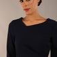 Model wearing DIVA Catwalk Peppard 3/4 Sleeve Pencil Dress in Cameo fabric knee length in navy blue colour front close up 