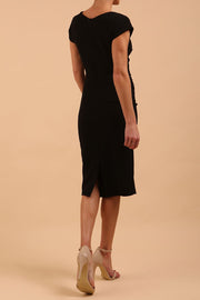Model wearing diva catwalk Syon Short Sleeved Pencil Dress with tie detail at the waist area in black colour back