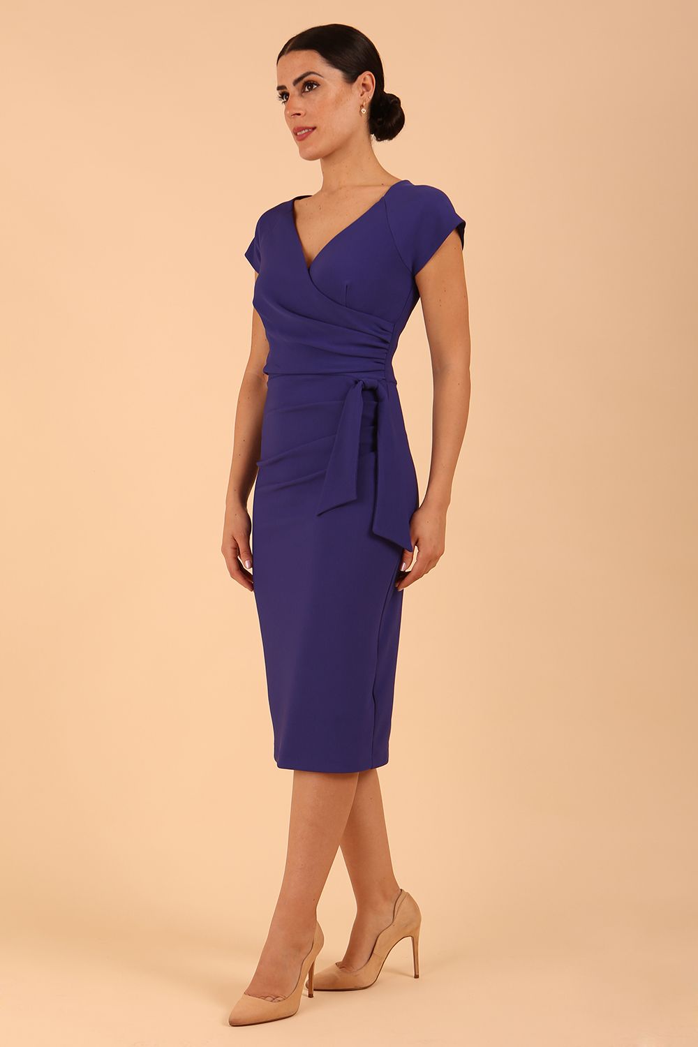 Model wearing diva catwalk Syon Short Sleeved Pencil Dress with tie detail at the waist area in Deep Orient Blue colour front side