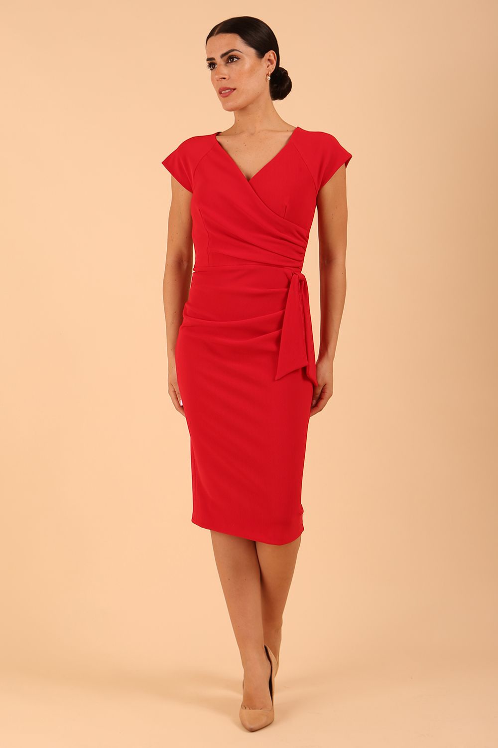 Model wearing diva catwalk Syon Short Sleeved Pencil Dress with tie detail at the waist area in True red colour front 