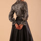 model wearing diva catwalk Zephyra Faux Leather Full Drape Skirt in black colour