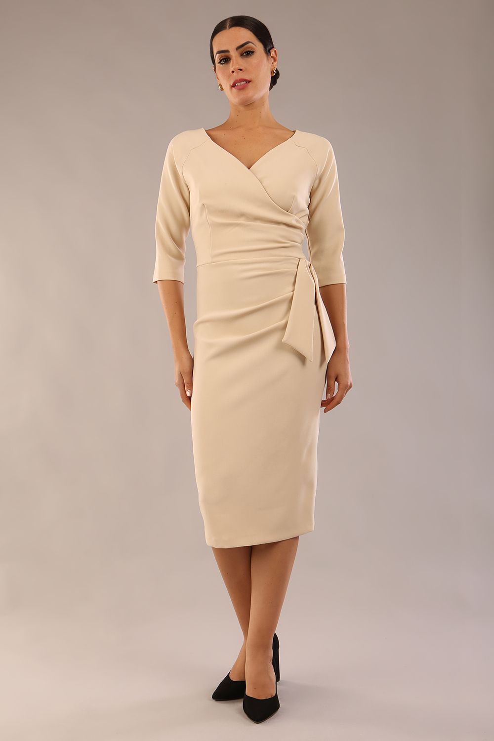 model wearon a diva catwalk Bronwen 3/4 sleeved Tie Pencil Dress in sandshell beige colour front