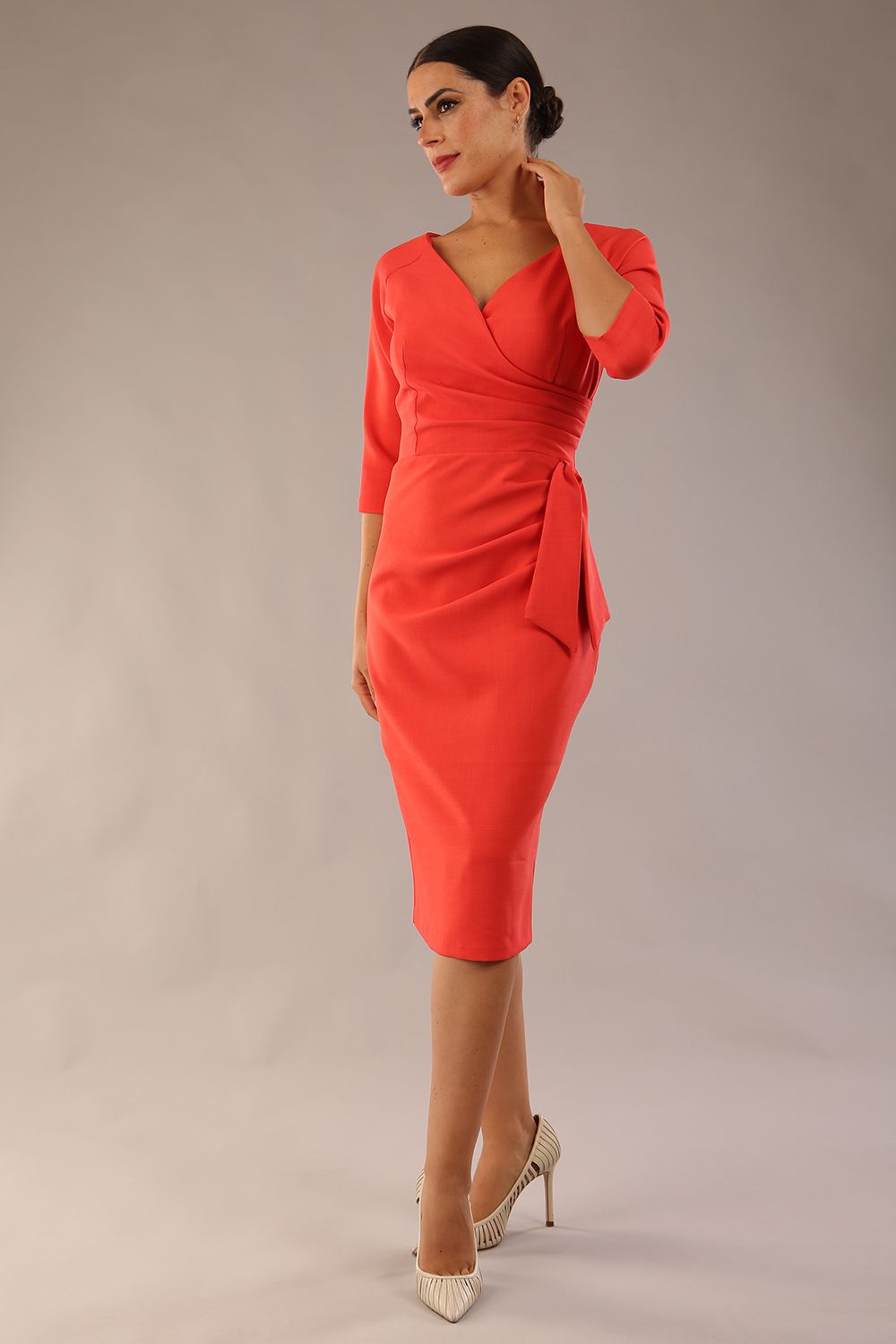 model wearon a diva catwalk Bronwen 3/4 sleeved Tie Pencil Dress in grenadine orange colour front