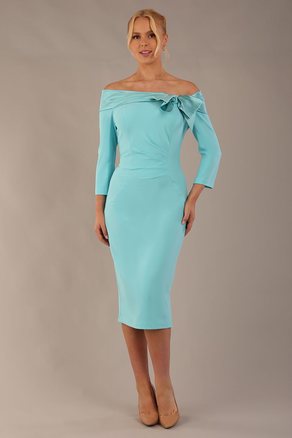 Model is wearing a diva catwalk Rosalind Off Shoulder Bow Detail Pencil Dress 3/4 sleeve in Turquoise contrast front image (Turquoise)