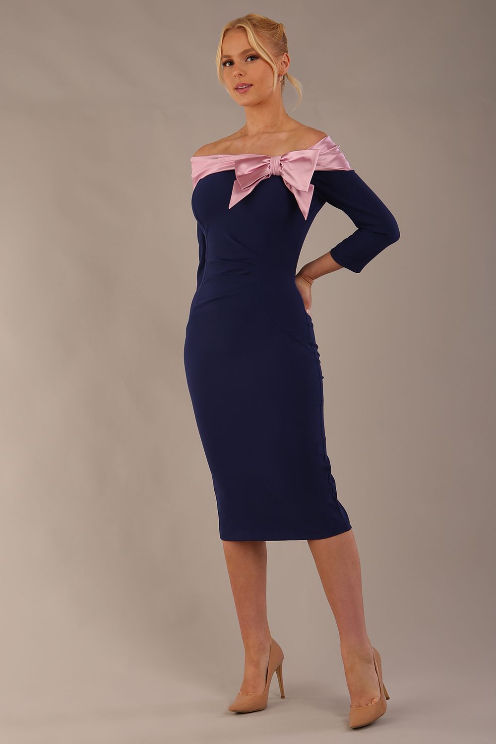 Model is wearing a diva catwalk Rosalind Off Shoulder Bow Detail Pencil Dress 3/4 sleeve in Navy Blue/Lilac Contrast contrast front image (Navy Blue / Lilac Contrast)