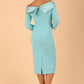 Model wearing a Rosalind Off Shoulder Bow Detail Pencil Dress 3/4 sleeve in Turquoise colour