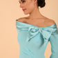 Model wearing a Rosalind Off Shoulder Bow Detail Pencil Dress 3/4 sleeve in Turquoise colour close up 