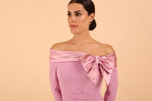Model wearing a Rosalind Off Shoulder Bow Detail Pencil Dress 3/4 sleeve in Dawn Pink colour close up