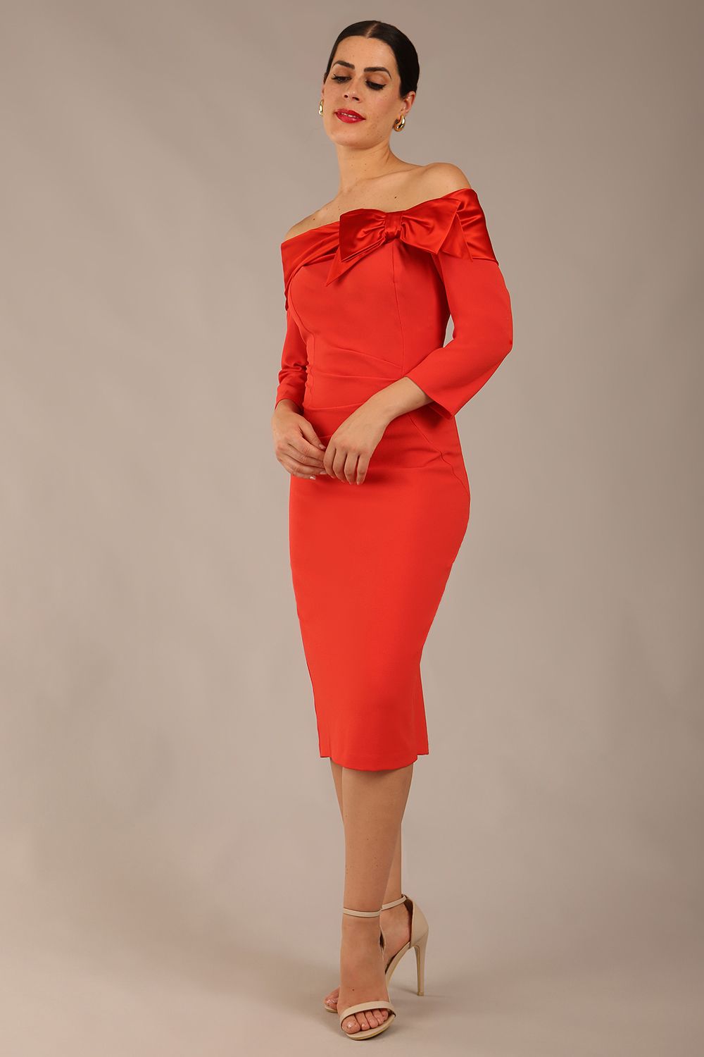 brunette Model is wearing a diva catwalk Rosalind Off Shoulder Bow Detail Pencil Dress 3/4 sleeve in Fiesta Orange/Fire Orange contrast front image