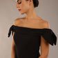 model is wearing a diva catwalk Strand Off-Shoulder Bow Tie Dress midi length and pleated skirt in black colour