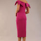 model is wearing a diva catwalk Strand Off-Shoulder Bow Tie Dress midi length and pleated skirt in magenta haze colour back