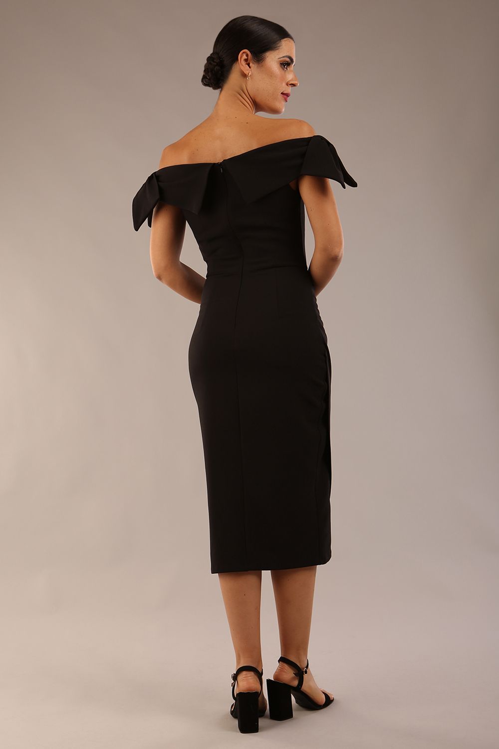 model is wearing a diva catwalk Strand Off-Shoulder Bow Tie Dress midi length and pleated skirt in black colour