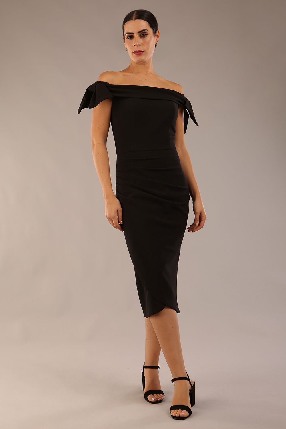 model is wearing a diva catwalk Strand Off-Shoulder Bow Tie Dress midi length and pleated skirt in black colour