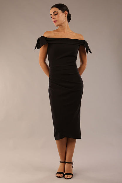 model is wearing a diva catwalk Strand Off-Shoulder Bow Tie Dress midi length and pleated skirt in black colour