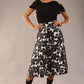 model is wearing a Gwendolyn Midi Length Skirt in Floral Print satin black and white a-line midi length skirt