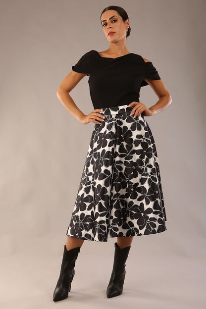 model is wearing a Gwendolyn Midi Length Skirt in Floral Print satin black and white a-line midi length skirt