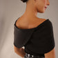 model wearing diva catwalk asymmetric neckline black short sleeve top