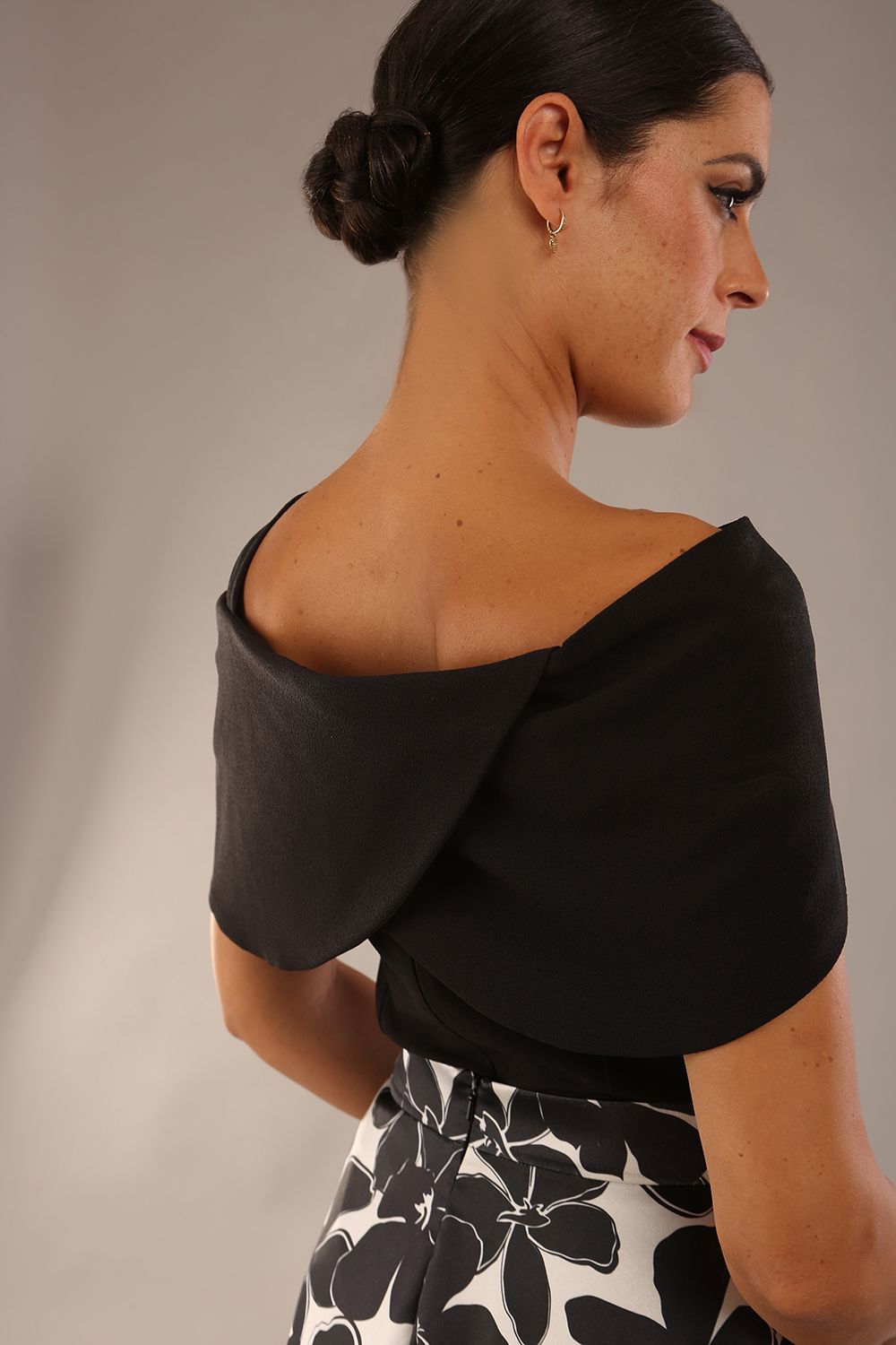 model wearing diva catwalk asymmetric neckline black short sleeve top