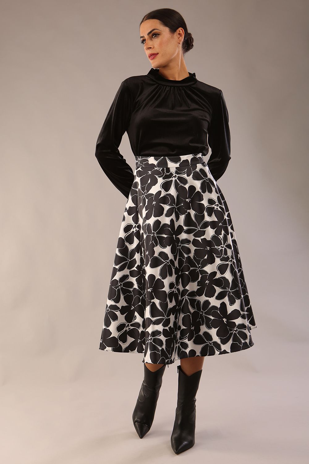 model is wearing a Gwendolyn Midi Length Skirt in Floral Print satin black and white a-line midi length skirt